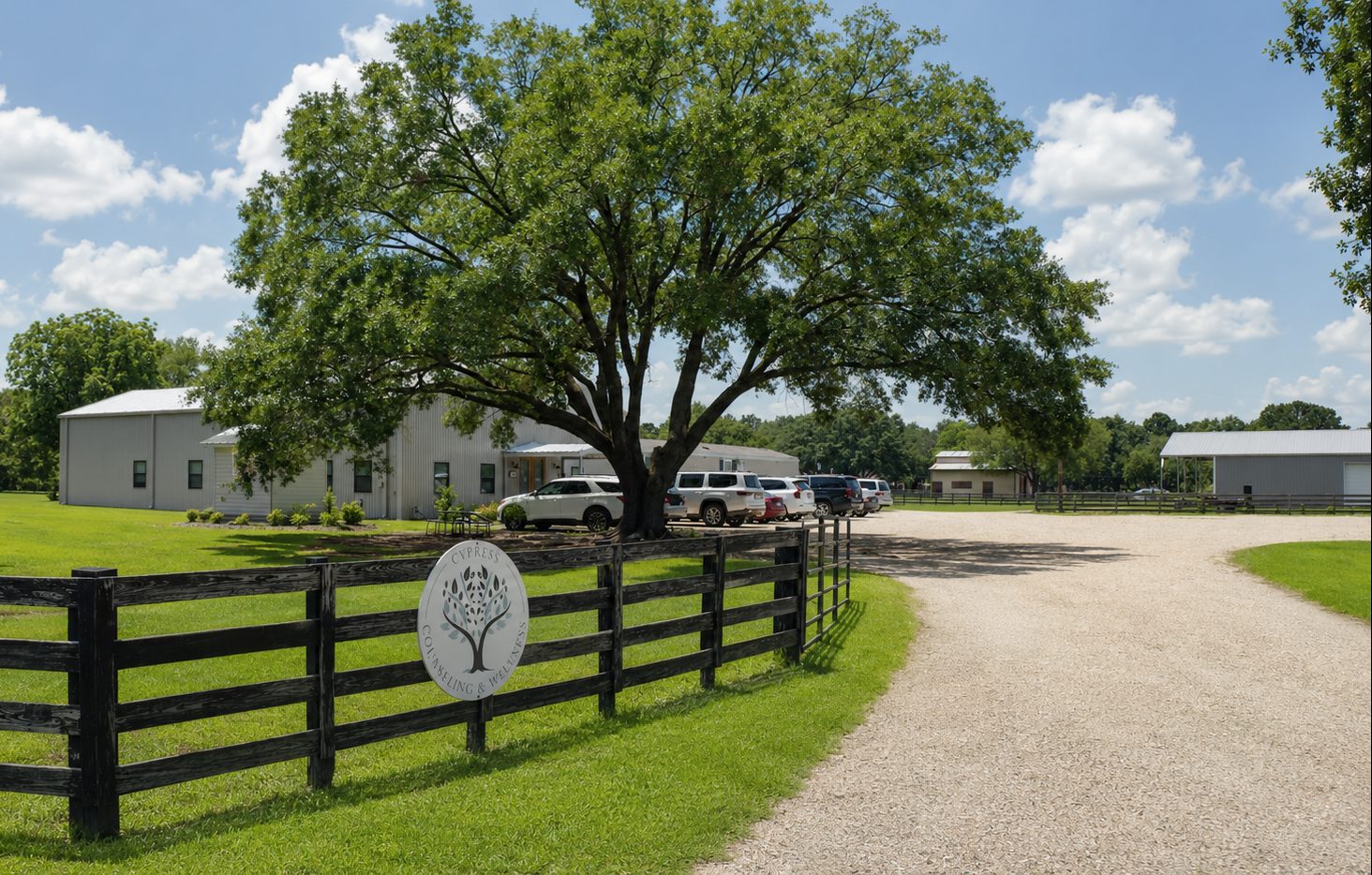 Cypress Wellness Campus exterior — gravel drive, mature oak tree, and building entrance